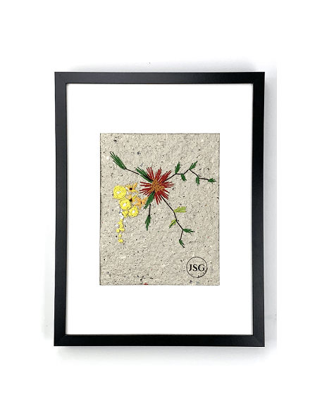 artwork of red yellow and orange flowers embroidered on homemade paper displayed in a black frame