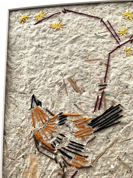 artwork of a brown bird made using embroidery on hand made paper