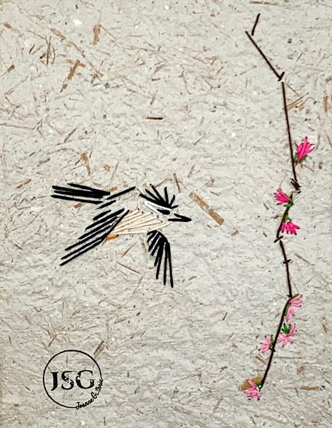artwork of a bird flying through the air beside a tree branch with pink flower displayed in a white frame