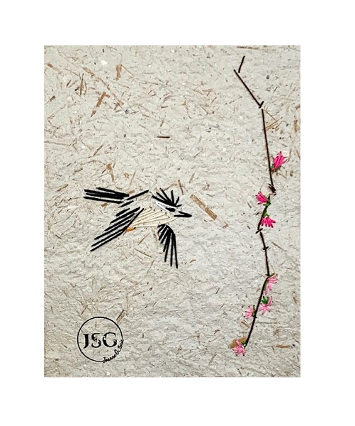 artwork of a bird flying through the air beside a tree branch with pink flower displayed in a white frame