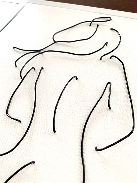 wire on canvas artwork of a nude female torso
