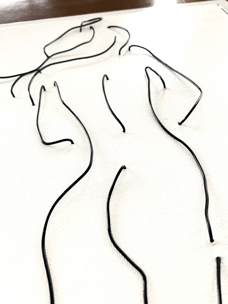 wire on canvas artwork of a nude female torso