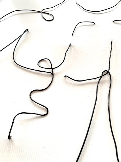 wire on canvas artwork of a nude male torso