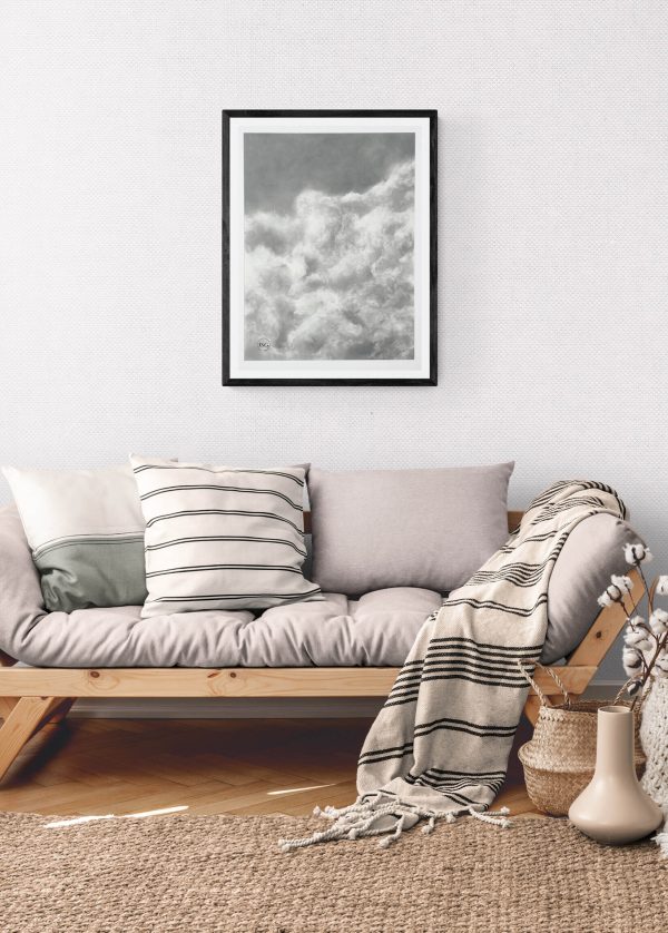 charcoal drawing framed at 21" x 29". This serene artwork captures the soft, airy beauty of drifting clouds, adding a touch of calm and elegance to any space.